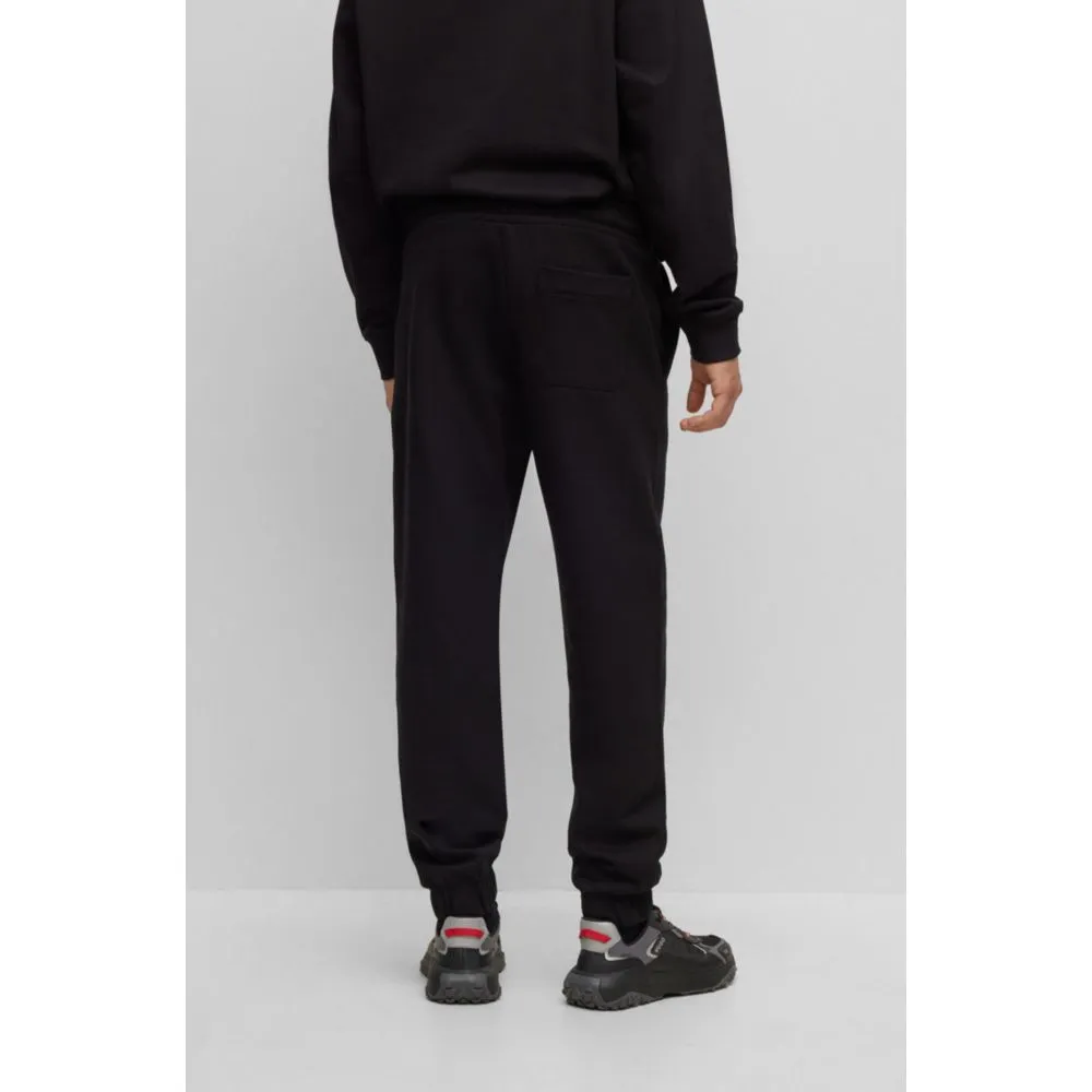 Relaxed-fit cotton-terry tracksuit bottoms with stacked logo
