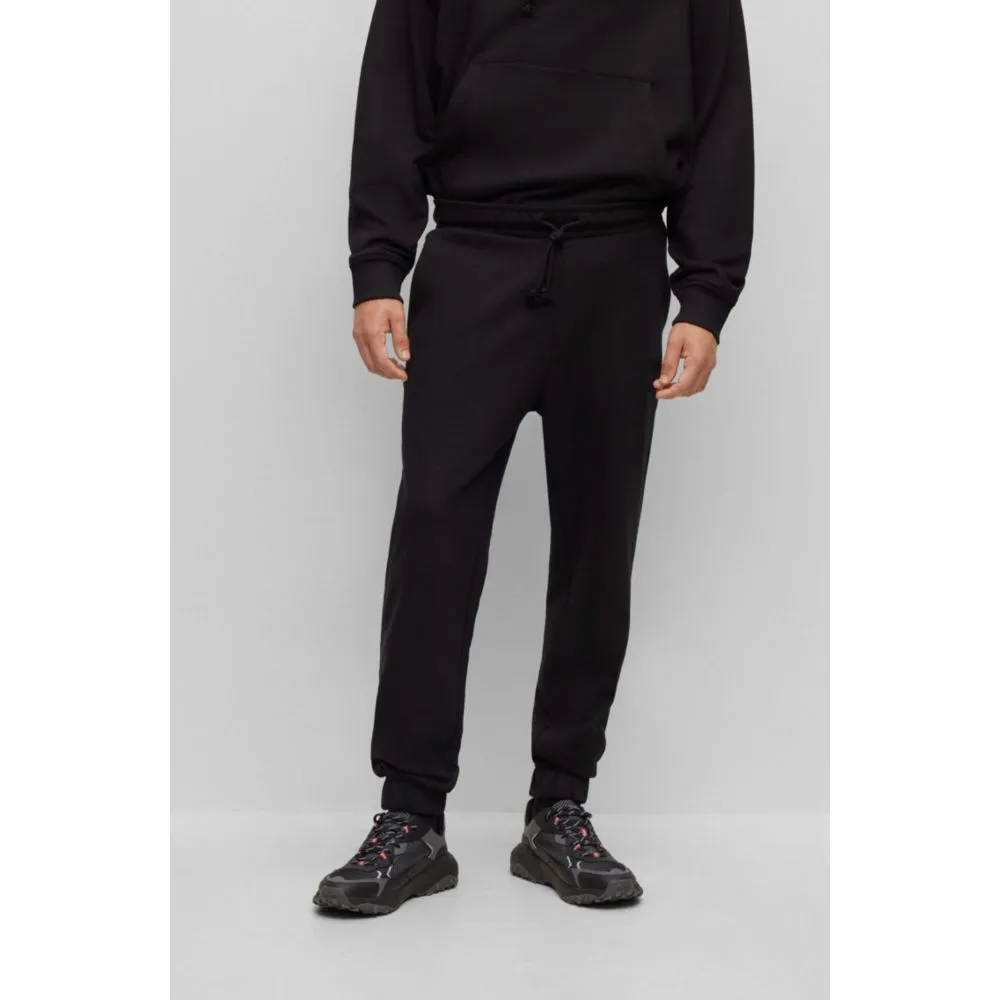 Relaxed-fit cotton-terry tracksuit bottoms with stacked logo